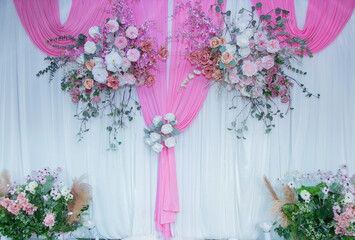 Beautiful flowers decorate the scene in the wedding.