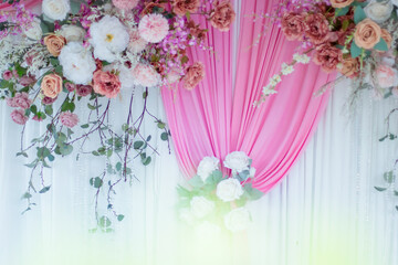 Beautiful flowers decorate the scene in the wedding.