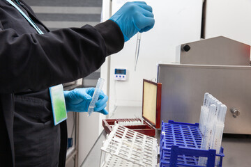 Female scientist preparing slides for karyotipe and fluorescence in situ hybridization at the laboratory