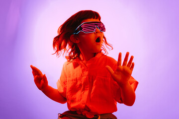 Little kid in neon glasses
