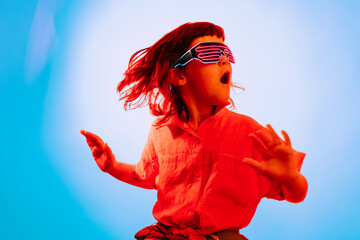 Little kid in neon glasses