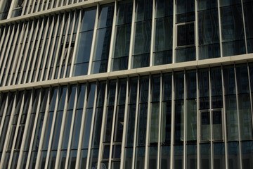 Metal building texture. Narrow windows in wall. Details of modern architecture.
