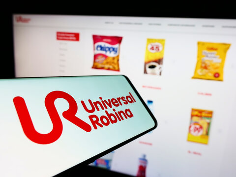 Stuttgart, Germany - 09-10-2022: Mobile phone with logo of company Universal Robina Corporation (URC) on screen in front of business website. Focus on center of phone display.
