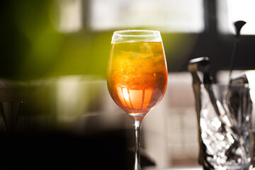 photography of aperol spritz cocktail glass with orange slice photo taken with light and shadow