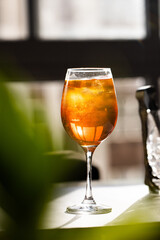 photography of aperol spritz cocktail glass with orange slice photo taken with light and shadow