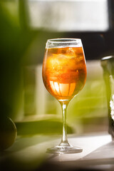 photography of aperol spritz cocktail glass with orange slice photo taken with light and shadow