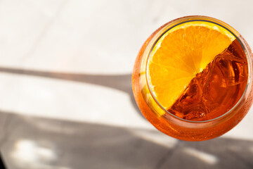 close up of aperol spritz cocktail with orange slice and ice