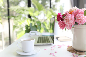 laptop side view and coffee and vase of roses work from home relaxation