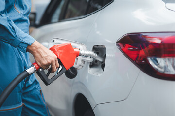 Gas station workers are refueling cars, fuel consumption, gasoline-powered cars, fluctuating oil prices, using alternative fuels for driving.
