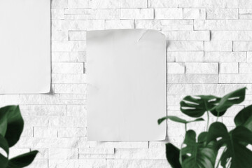 Clean minimal poster mockup on bricks wall with leaves