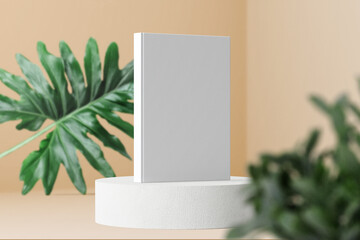 Clean minimal photo book 5.5x8.5 mockup standing on block with leaves