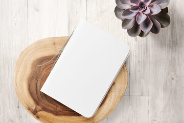 Clean minimal cover notepads mockup on top table with wooden plate and plant