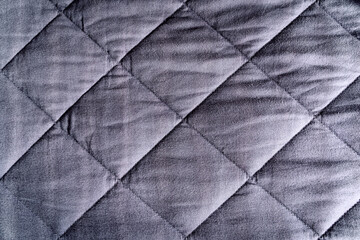 Grey blue weighted blanket texture detail, heavy padded relaxing bed sheet cover filled with glass beads