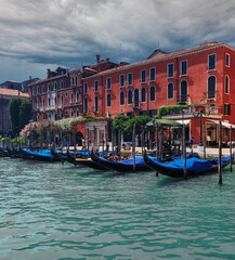 Gondolas floating on the Grand Canal before the storm in Venice, Italy