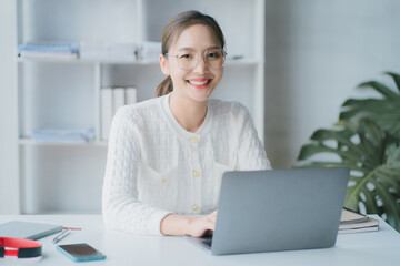 Asian woman enjoy listening to music and drinking coffee and laptop computer in the morning