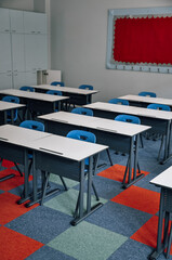 Empty classroom and school with wooden table and iron chair for primary education, education concept with carpet