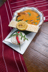 tom yum soup on a wooden table.