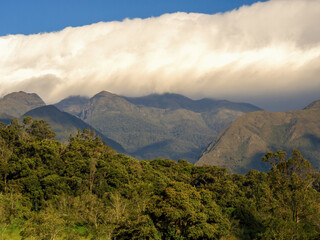 A dense cloud floats over the mountains of the Iguaque region at sunset in the eastern Andes range of central Colombia