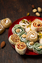Assorted oriental sweets on a red plate