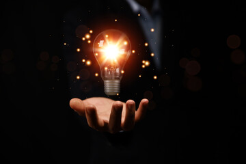 businessman holding a light bulb graphic Digital technology abstract. idea Creative