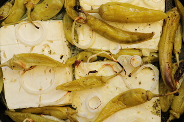 Baked feta cheese with pepperoni and onions