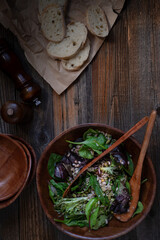 Obraz na płótnie Canvas Vegan greens salad on wooden background, overhead, copy space