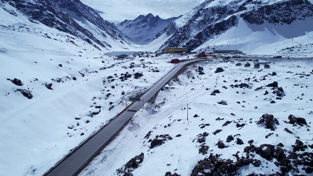Highway road at snowy vast mountains at Santiago Chile. Andes Mountains. Winterness scenery. Vastness scenery. Travel destinations. Vacations travel.