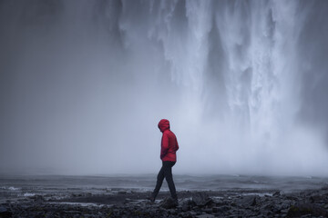 Walking in Front of Iceland Waterfall - obrazy, fototapety, plakaty
