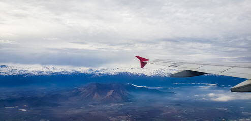 Flight on a plane, over the Andes - Chile, Pucon region. Mountains, snow and volcanos.
