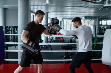 Boxer practicing with personal trainer