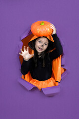 Laughing funny child girl in a devil  costume in halloween