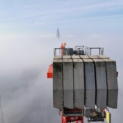 Tower Crane in the clouds the Shard, London in the background 
