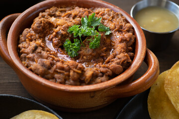 Vegan refried beans in clay pot 