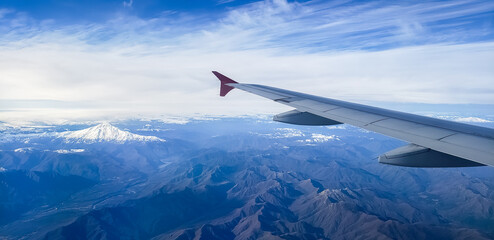 Flight on a plane, over the Andes - Chile, Pucon region. Mountains, snow and volcanos.