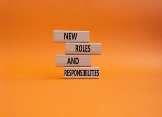 New roles and responsibilities symbol. Wooden blocks with words New roles and responsibilities....