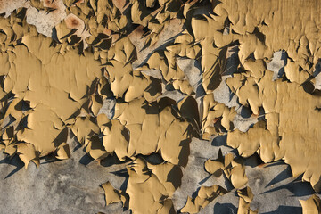 Metal background with cracked paint. The texture of the exfoliating paint of the paint. Background of old painted metal. Peeling paint on metal.