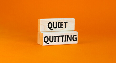 Quiet quitting symbol. Concept words Quiet quitting on wooden blocks. Beautiful orange table orange background. Business and quiet quitting concept. Copy space.
