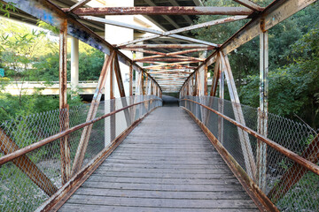 A pedestrian iron bridge leading into the city of Austin TX
