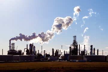 Channahon, Illinois, USA - March 27, 2022: An oil refinery facility skyline. An oil refinery is a facility that takes crude oil and distills it into various useful petroleum products.  