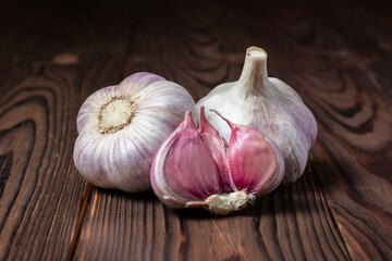 Garlic cloves on wooden table. Fresh peeled garlics and bulbs.