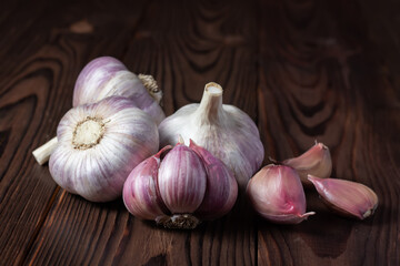Garlic cloves on wooden table. Fresh peeled garlics and bulbs.