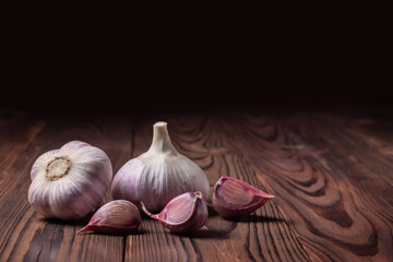 Garlic cloves on wooden table. Fresh peeled garlics and bulbs.