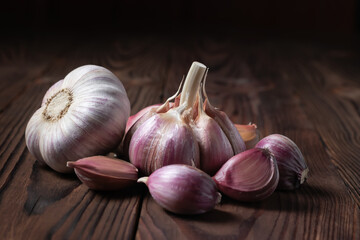 Garlic cloves on wooden table. Fresh peeled garlics and bulbs.