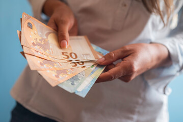 girl holding euro banknotes in her hands