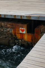 heart mosaic made of ceramic tiles above the water. High quality photo