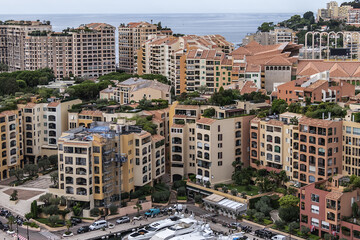 Fototapeta premium Panoramic view of Fontvieille - district of Monaco with boats and a high-rise apartment complex. Principality of Monaco, French Riviera, Western Europe.