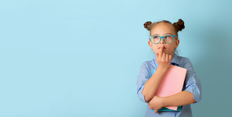 Happy girl with Down syndrome having fun in the studio with books. Banner