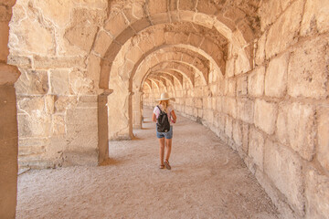 Fototapeta na wymiar Woman tourist visiting The Theatre of Aspendos Ancient City in Antalya