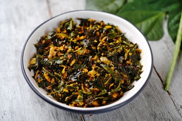 Green beans leaves stir fried with coconut and turmeric, selective focus