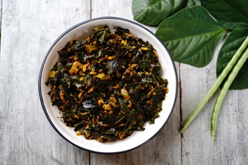 Green beans leaves stir fried with coconut and turmeric, selective focus